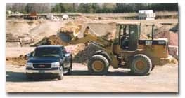 Wheel loader filling a pickup truck with bulk material in Tecumseh, Michigan