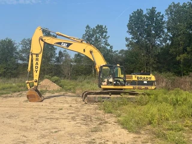 Brady Sand & Gravel CAT excavator parked at a cleared job site
